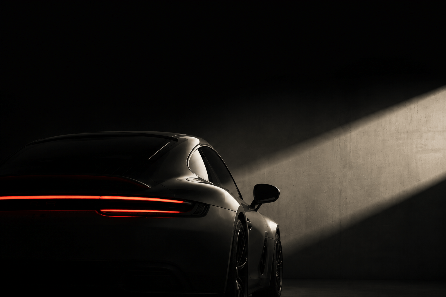 Black sports coupe in a minimal studio