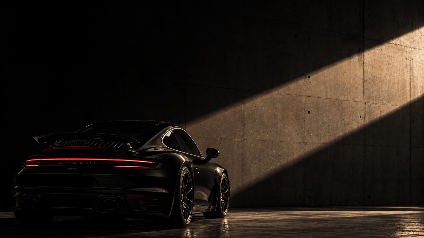 Black sports coupe in dramatic directional light