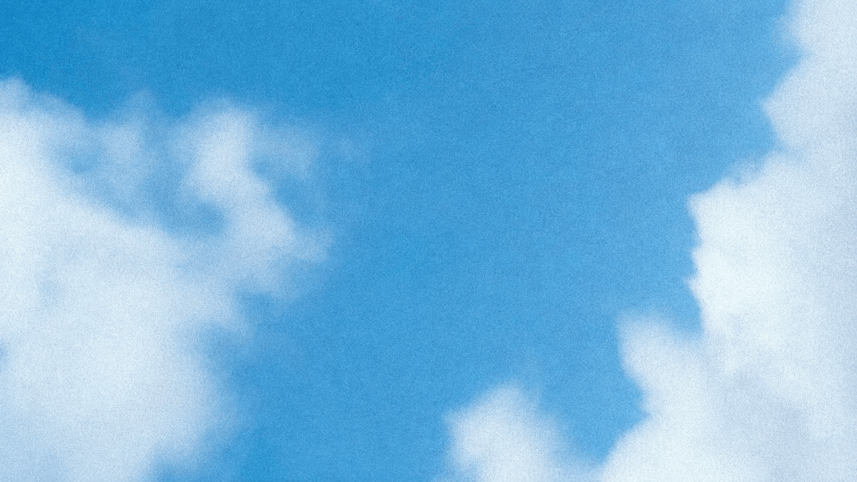 Soft white clouds in a grainy blue sky